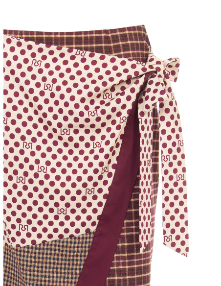 Lange patchwork-wikkelrok met knoopdetail aan de zijkant Rinascimento